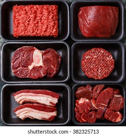 Different types of raw meat in plastic boxes packaging tray