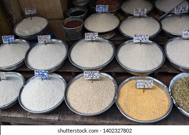 Different types of rice in bowls for sale on farmers market in Vietnam. Street food stall display