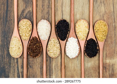 Different Types Of Rice In A Wooden Spoon.