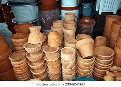 Different types and sizes of stacks clay pots(for planting) were on sale at the garden market.