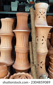 Different types and sizes of stacks clay pots(for planting) were on sale at the garden market.