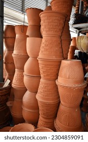Different types and sizes of stacks clay pots(for planting) were on sale at the garden market.