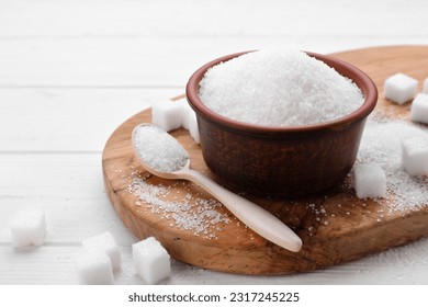 Different types of sugar on white wooden table, space for text