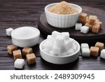 Different types of sugar on wooden table