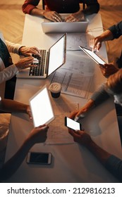 Different types of technology can help your business maximize efficiency. High angle shot of a group of designers using modern technology in a meeting.