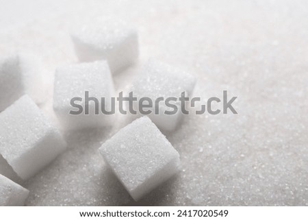 Different types of white sugar as background, closeup. Space for text