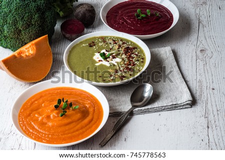 Different vegan food. Colorful vegetables cream soups and ingredients for soup. Healthy eating, dieting, vegetarian kitchen and cooking concept.