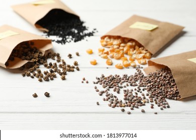 Different Vegetable Seeds On White Wooden Table