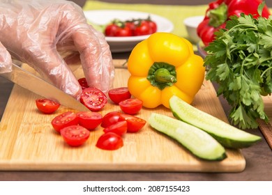 Different Vegetables For Cooking Healthy Vegetarian Vegan Diet Food. Chef Hands In Cellophane Gloves Cutting Tomato Close Up