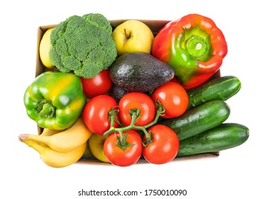 Different vegetables, fruits in cardboard box on white, top view. Healthy vegetarian food. Food donation, online shopping or contactless delivery service concept. Avocado, pepper, tomato and broccoli