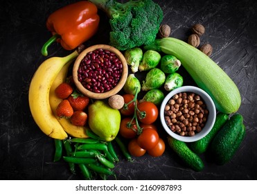 Different vegetables and fruits on an old background