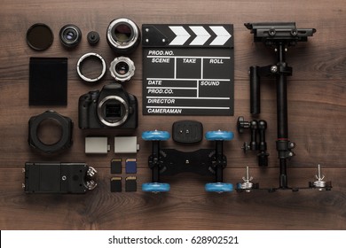 different video making equipment for indie production on brown wooden table view from above. short movie production essentials
