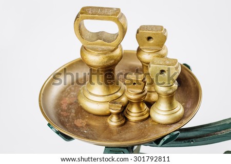 Different vintage brass weights unit standing on white background