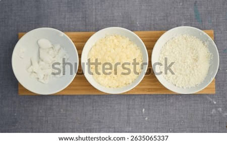 Different wax types for candle making displayed in bowls