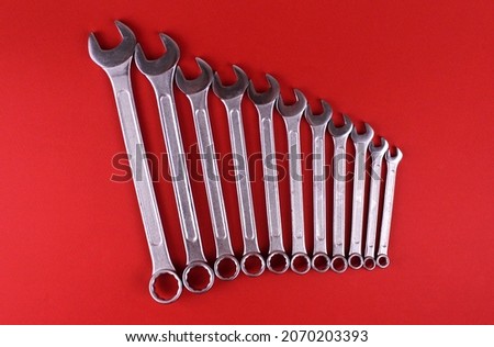 Different wrenches on a red background. Set of wrenches