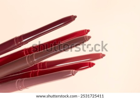 Differential pencils for lips and eyebrows close-up. Cosmetic product. Copy space