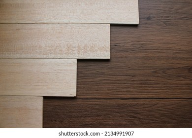 Different-level planks are laid out on wooden floors of different colors. - Shutterstock ID 2134991907