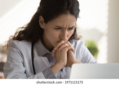 Difficult Case. Thoughtful Female Doctor Look At Office Computer Screen Ponder On Establishing Correct Diagnosis Choose Treatment. Hard Thinking Medic Study Medical File Of Patient With Rare Disease