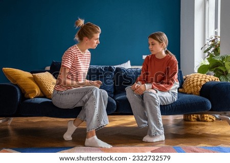 Difficult conversation between single mother and teenager at home. Important conflict adolescent topic between woman and daughter. Family misunderstanding. Upset teen girl listens to mom admonitions 