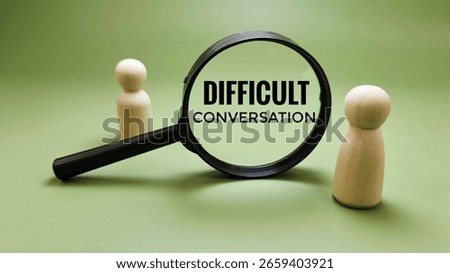 Difficult Conversation Between Two Wooden Dolls Seen Through Magnifying Glass Representing Conflict, Miscommunication, and Emotional Tension in Dialogue. 