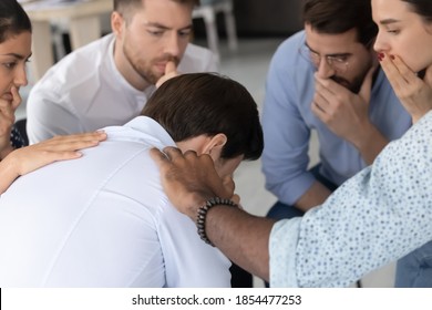 Difficult Moment. Compassionate Multiethnic Colleagues Friends Supporting Depressed Frustrated Young Man In Hard Period Of Life, Diverse Partners Showing Empathy To Male Mate On Group Therapy Session