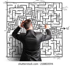 Difficult resolution of a maze by a troubled businessman - Shutterstock ID 218803594