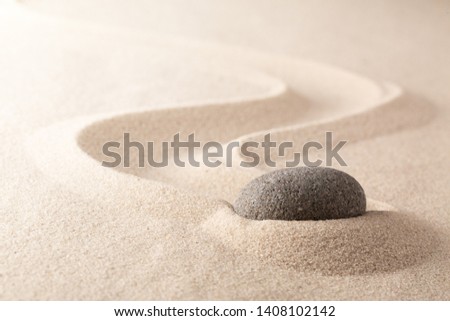 Difficult slow progress stone in sand garden. Concept for will power and endurance to overcomeresistance, hindrance of refusal