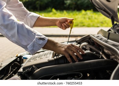 Difficult Stain - Man In White Shirt With Grease Smear On The Sleeve, Checking Oil Level In The Car With Open Hood.