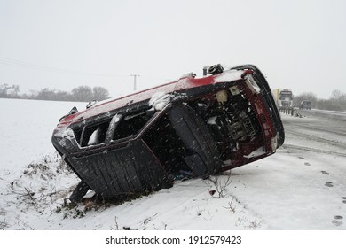 Difficult Winter Snow Condition Car Accident Concept, Car Lying On Its Side After Hard Crash