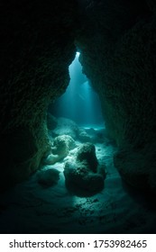 Diffused sunlight descends into a dark, submerged cavern at the southern tip of Yap. Underwater caves and crevices offer shadowed habitats for creatures that do not like light.