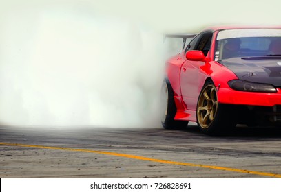 Diffusion race drift car with lots of smoke from burning tires on speed track