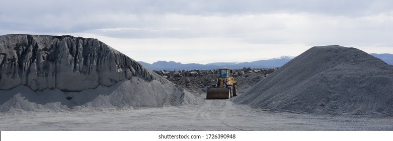 Digger in the midst of black sand tails in a lava sand pit in Iceland - Shutterstock ID 1726390948