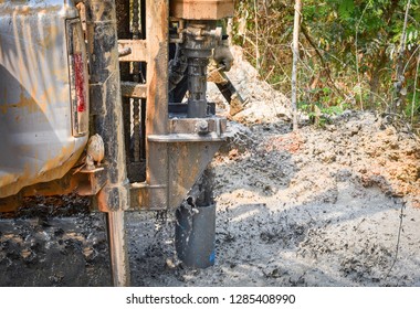 Digging Hole Drilling Groundwater Machine Installed On Deeps Ground Soil And Mud / Groundwater Testing And Sampling Pollution Concept