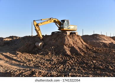 Digging The Pit Foundation A Hole With Excavator. Earthwork In Excavation And Backfilling Of Soil Upto Required Depth Is Required For Construction Of Trenche. Construction Machinery For Earthmoving
