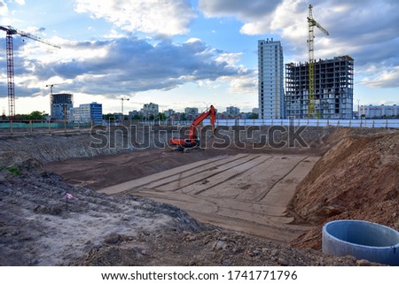 Digging the pit foundation a hole with excavator. Earthwork in excavation and backfilling of soil upto required depth is required for construction of trenche. Construction machinery for earthmoving