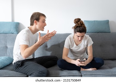Digital addiction and cohabitation problems concept. Woman concentrated on social media ignoring boyfriend.