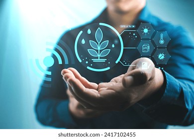 Digital Agriculture Innovation with Smart Farming Icons :Person holding a digital interface with icons representing smart farming and agricultural technology advancements. - Powered by Shutterstock