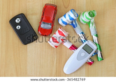 Digital Alcohol Breath Tester Device In White Next To A Car Remote Key And Colorful Party Digital Alcohol Breath Tester Device In White Next To A Car Remote Key And Colorful Party