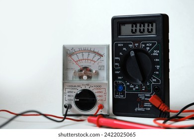 Digital and analog devices in the same frame. Two different types of multimeters. Electrical - electronic test and measurement devices.