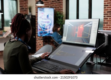 Digital artist sitting at desk, using PC to design game environment and levels. Development department creator employee working with CGI in order to achieve virtual realism. - Shutterstock ID 2150291073