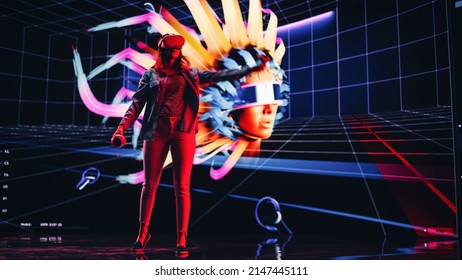 Digital Artist Using Virtual Reality 3D Software To Create A Beautiful Piece Of Art In Interactive Creative Environment. Female Designer Using Virtual Reality Headset And Controllers For NFT Project.