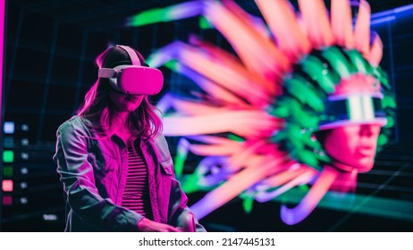 Digital Artist Using Virtual Reality 3D Software To Create A Beautiful Piece Of Art In Interactive Creative Environment. Female Designer Using Virtual Reality Headset And Controllers For NFT Project.