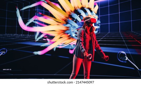 Digital Artist Using VR Software To Create A 3D Piece Of Art: Designing A Stylish Futuristic Portrait In Interactive Environment On A Big Digital Screen. Female Designer Using Headset And Controllers.