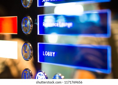 Digital Blue Light Elevator Panel With Level Buttons Show Informative Screen Besides Indicate Each Floor Location Of Hotel / Office Building; Lobby, Lounge And Restaurant. Focus On 1st Floor Lobby.