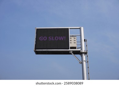 The digital board is instructing the drivers to drive slow