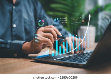 Digital business marketing data management on virtual screen, Businessman use laptop work marketing analysis chart strategic planning analytics dashboard with management data work in modern office  - Powered by Shutterstock