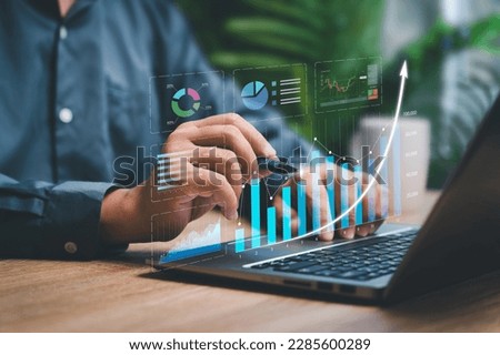 Digital business marketing data management on virtual screen, Businessman use laptop work marketing analysis chart strategic planning analytics dashboard with management data work in modern office 