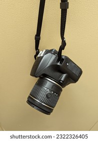 Digital camera hanging from a hook