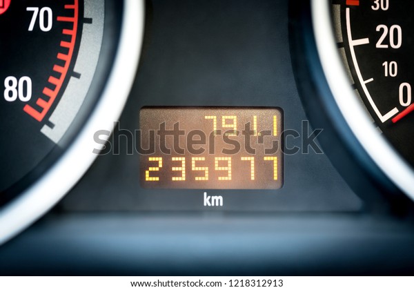 Digital car odometer in dashboard. Used\
vehicle with mileage meter. Numbers in\
kilometers.