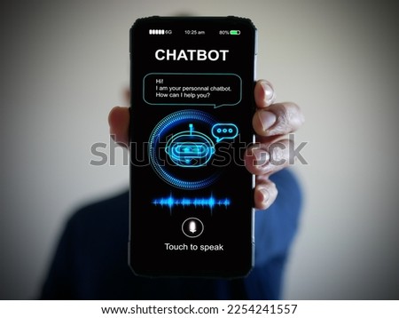 Digital chatbot, conversational agents, robot application, conversation assistant that mimic human speech. Hand holding smartphone with digital AI chatterbot on virtual screen for online information. 